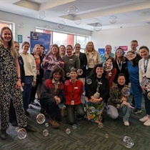 A group of people standing together indoors